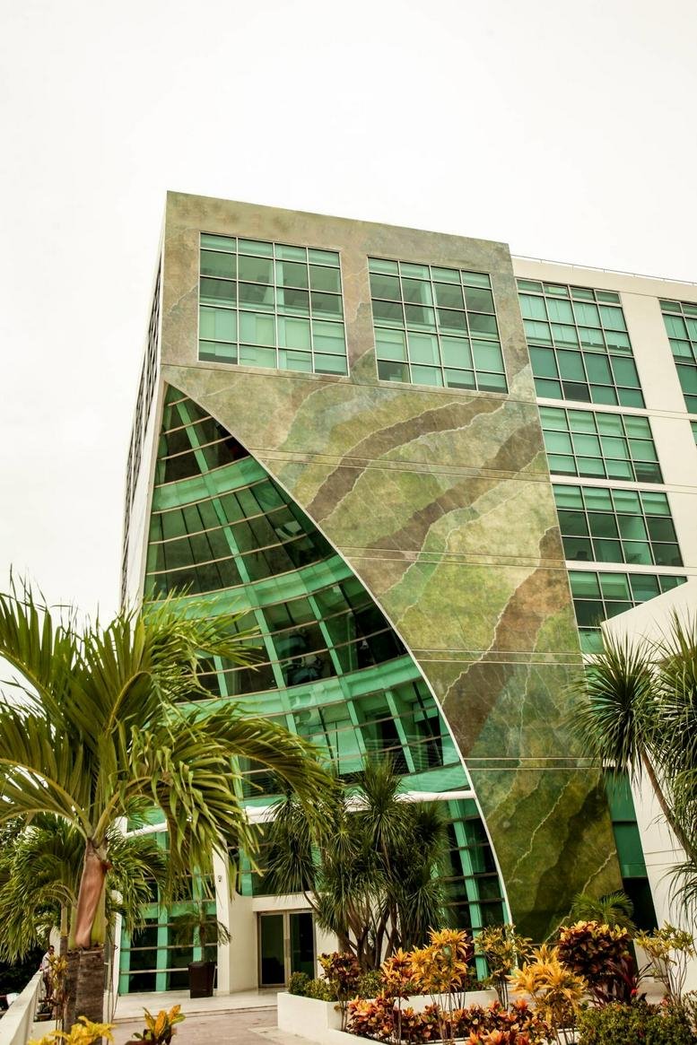 The uniquely designed glass and stone facade of the Tulum Trade Centre building.