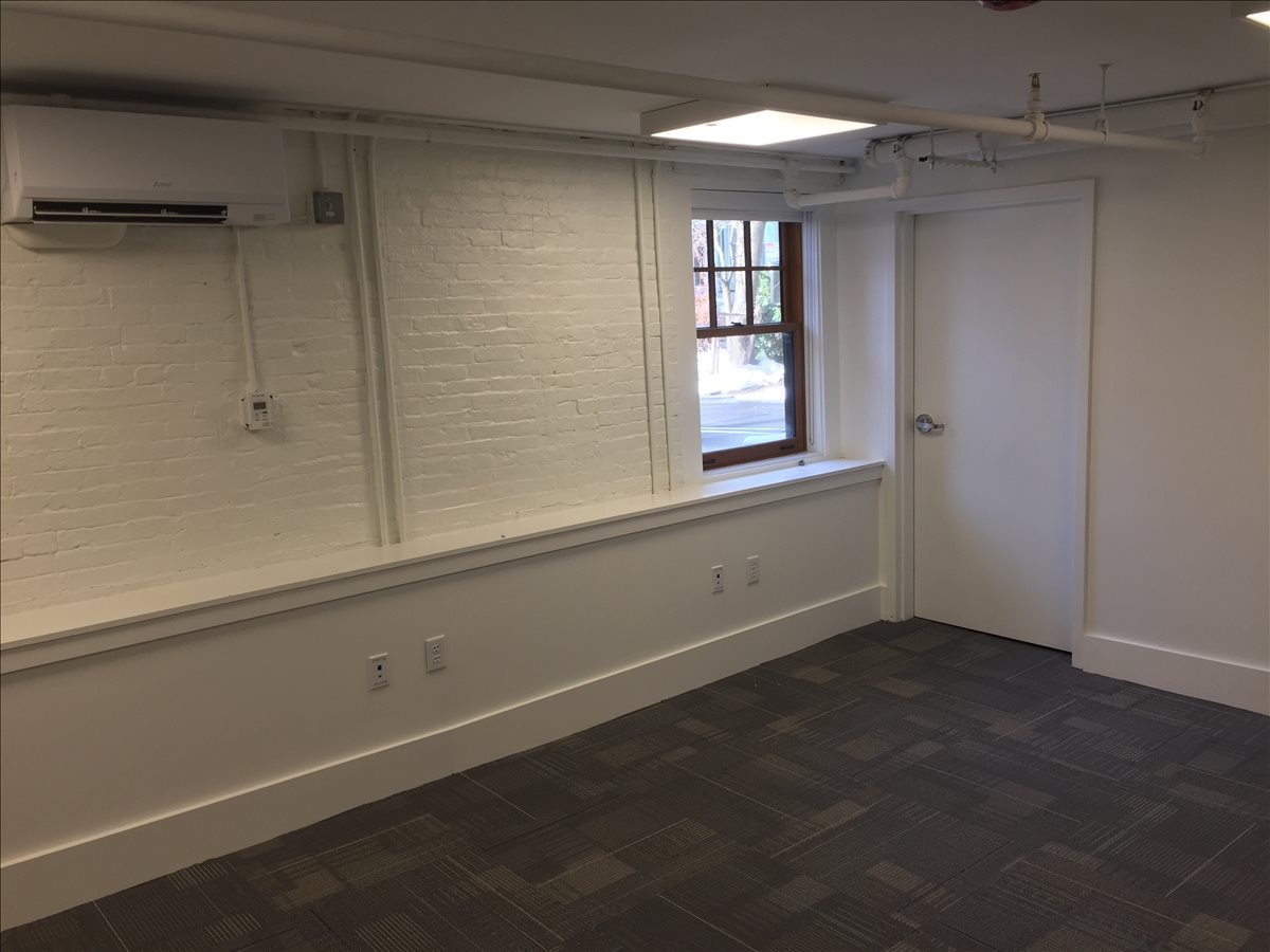 Internal view of Suite 100 at 99 Bishop Allen Drive showing a window and clean white finishes.