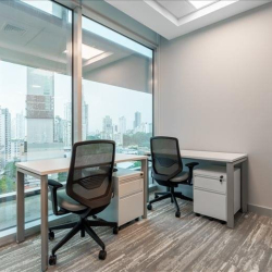 Bright two-person office with floor-to-ceiling windows and panoramic city views.