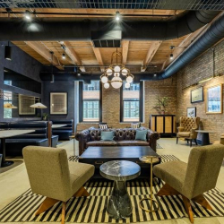 Lounge area at 1101 West Lake Street with brick walls and eclectic seating.