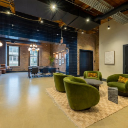 Private office suite with three large windows and multiple desks.