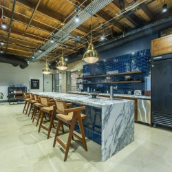 Stylish lobby with green velvet armchairs and a marble reception counter.