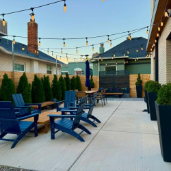 Relaxing outdoor space with comfortable seating and festive string lighting.