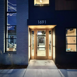 Building entrance with address 1691 above a glass-paneled wooden door.