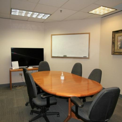 Bright boardroom with a large conference table and built-in whiteboard.