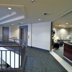Upper-level atrium view looking down into the building entrance and bright lobby area.