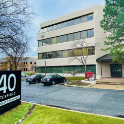 Exterior entrance view showing the building facade and street address sign.