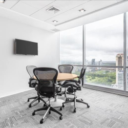 Small meeting room with a round table and expansive city views.
