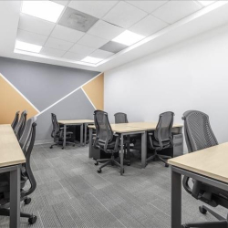 Internal office suite with desks and a geometric feature wall.