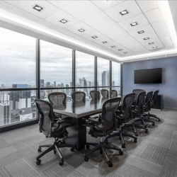 Large boardroom with a long table and panoramic city views.