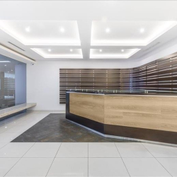 Professional reception area with a sleek wooden front desk.