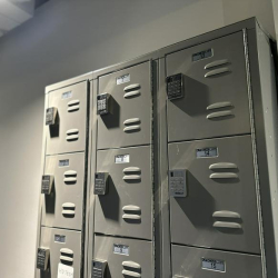 Set of secure grey metal lockers featuring digital keypad locks for staff storage.