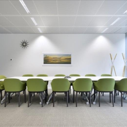 Large meeting room with green chairs and a white table at 4121 E Auto Valley Drive, 1st Floor.