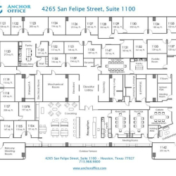 Bright reception area featuring a long wooden desk and comfortable blue armchairs by large windows.