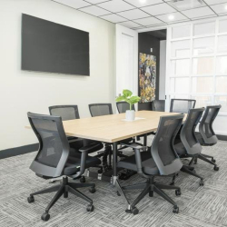 Modern open-plan workspace featuring a core values wall graphic and polished floors.