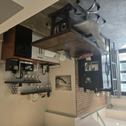 Industrial-style breakroom at 803 21 Ave SE with a large wooden table and open shelving.