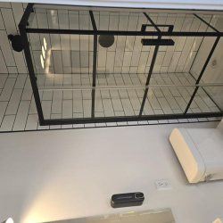 Modern bathroom with a glass shower enclosure and subway tiling.