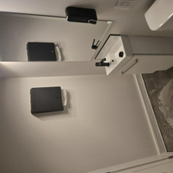 Clean bathroom interior with a white vanity and large wall mirror.