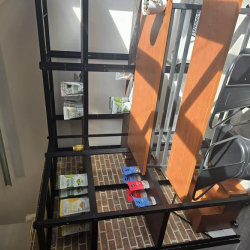 Black metal shelving frame used for storage in a workshop area.