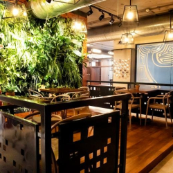 Lecture-style room with rows of chairs facing a presentation screen.