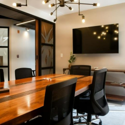 Lounge area featuring a vibrant vertical plant wall and warm pendant lights.