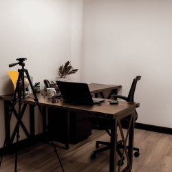 Private workspace with a wooden desk, laptop, and camera tripod setup.