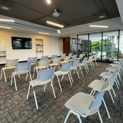 Training room with multiple wooden tables and seating for group sessions.