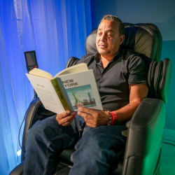 Modern office suite with an adjustable desk and large windows.