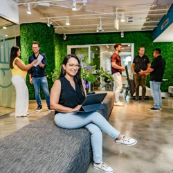 Open workspace with lush snake plants and a professional atmosphere.