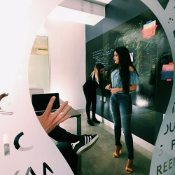 Office reception area with a vertical garden wall and workspace desks.