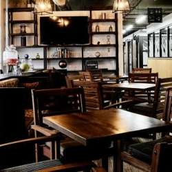 Shared workspace hallway featuring decorative glass patterns and industrial-style lighting.