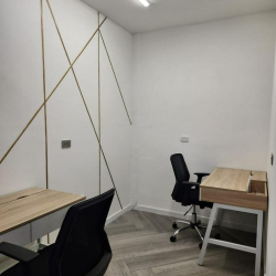 Private office featuring gold geometric wall details and ergonomic black chairs.
