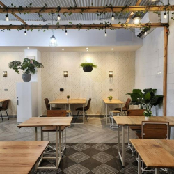 Private office suite with wooden workstations and patterned chevron flooring.