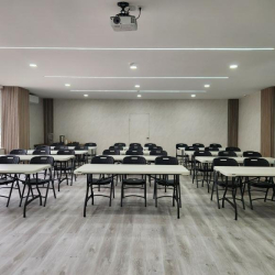 Workspace featuring dark wood desks and tall industrial black metal shelving.