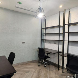 Industrial-style workspace with black metal shelving and dark wooden desks.