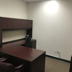 Private office suite featuring dark wood L-shaped desk at 10015 Old Columbia Rd, Suite B215, Columbia.