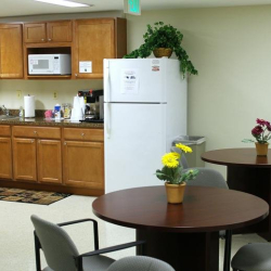 Office breakroom with kitchenette and small dining tables at 10015 Old Columbia Rd, Suite B215, Columbia.