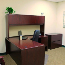Corner office with dark wood desk and guest chairs at 10015 Old Columbia Rd, Suite B215, Columbia.