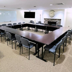 Large boardroom with U-shaped table and wall-mounted TV at 10015 Old Columbia Rd, Suite B215, Columbia.