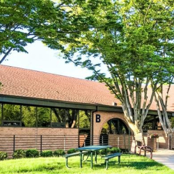 Exterior view of brick office building with green landscaping at 10015 Old Columbia Rd, Suite B215, Columbia.