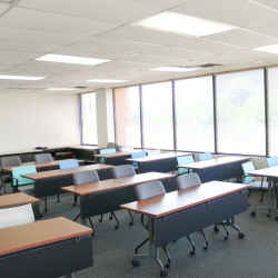 Casual breakout space with high tables and private phone booth, 1903 Central Drive, Bedford, Texas.