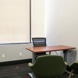 Modern boardroom with long white table and blue office chairs, 1903 Central Drive, Bedford, Texas.