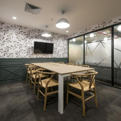 Formal boardroom featuring a white marble table and mesh chairs, Avenida Manuel Olguín 327, Lima, Peru.