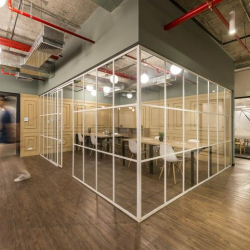 Modern glass partition overlooking a shared office space, Avenida Manuel Olguín 327, Lima, Peru.