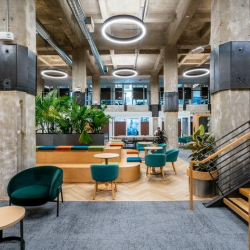 Elevated view of a multi-level coworking space with tiered seating and plants.