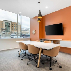 Modern meeting room with orange feature wall and TV, Traverse Ridge Center III, Lehi, Utah