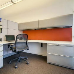 Individual cubicle workspace with storage and orange divider at Marina Del Rey office.