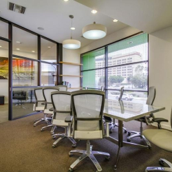 Large glass-walled conference room with white chairs and modern fixtures, Marina Del Rey, California.