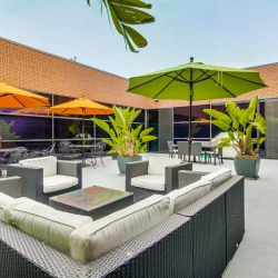 Outdoor terrace with lounge seating and umbrellas at 475 Washington Boulevard, Marina Del Rey.