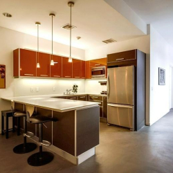 Sleek communal kitchen with breakfast bar and modern appliances, Marina Del Rey, California.